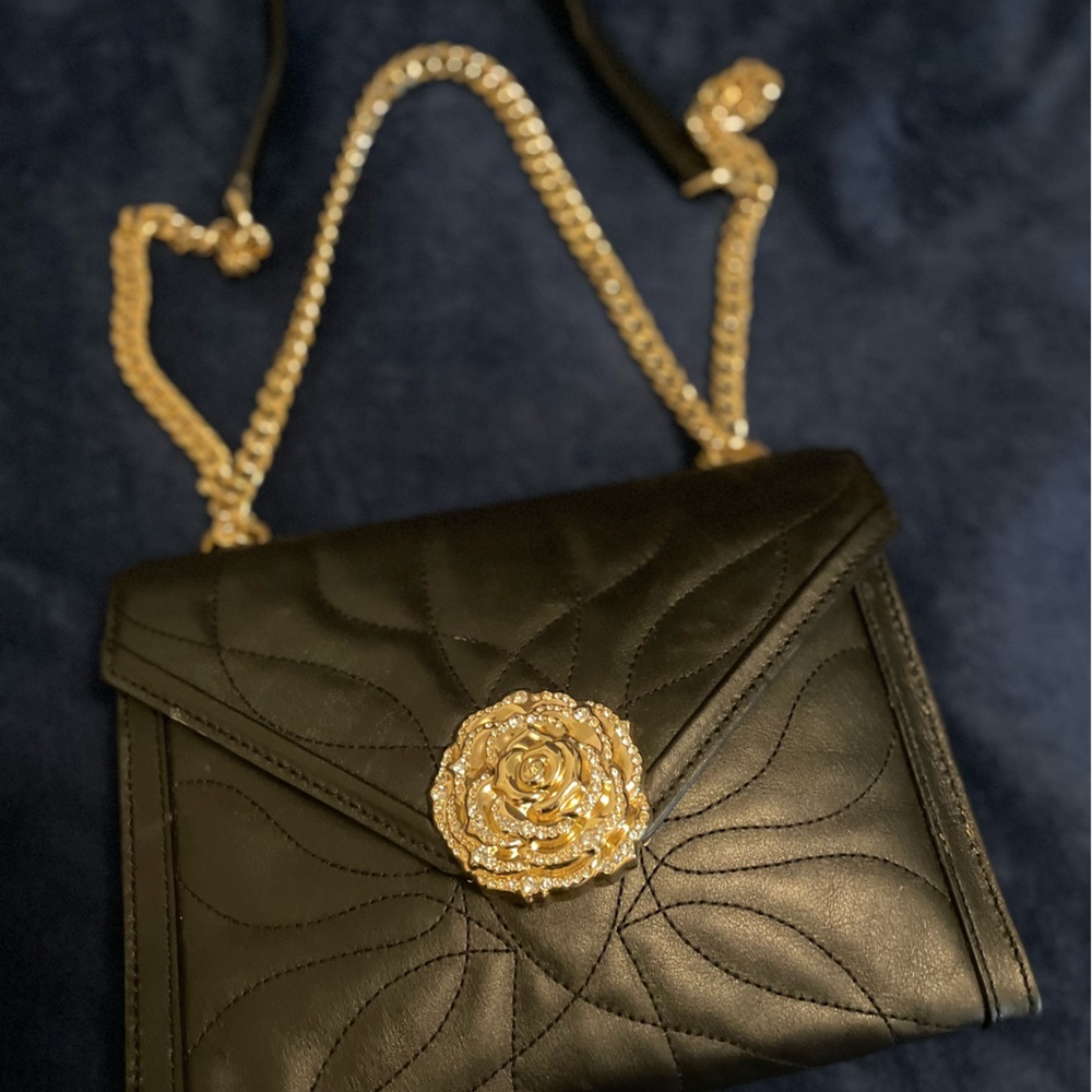 Michael Kors gold link strapped purse.